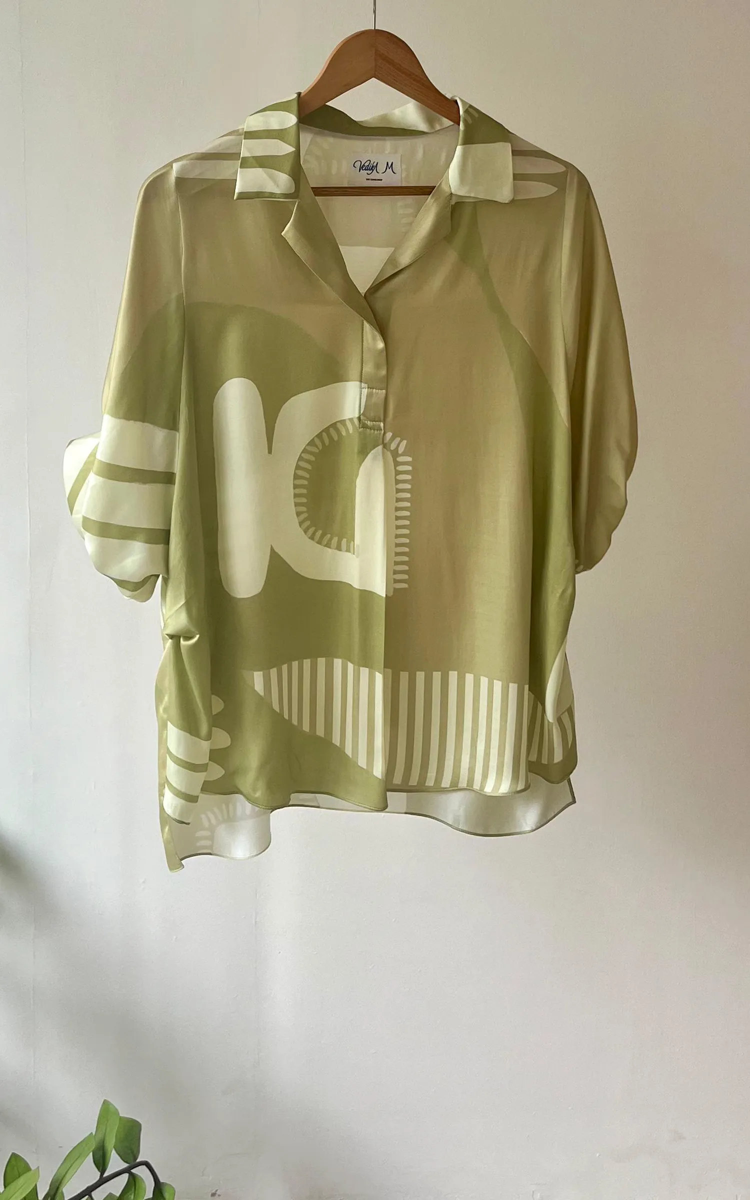 Green Abstracted Printed V neck Top.