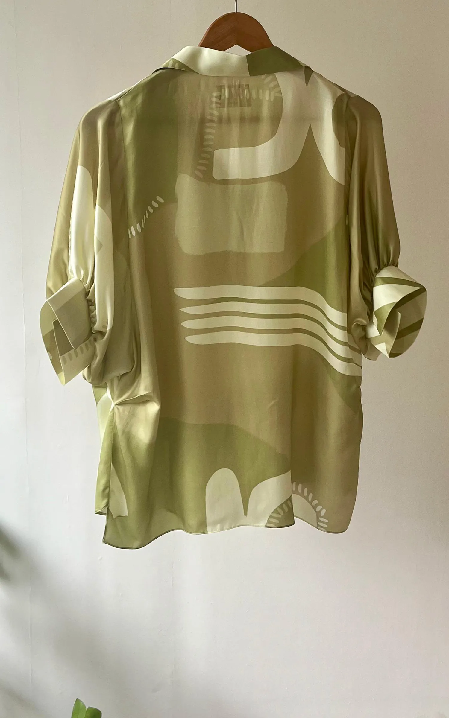Green Abstracted Printed V neck Top.