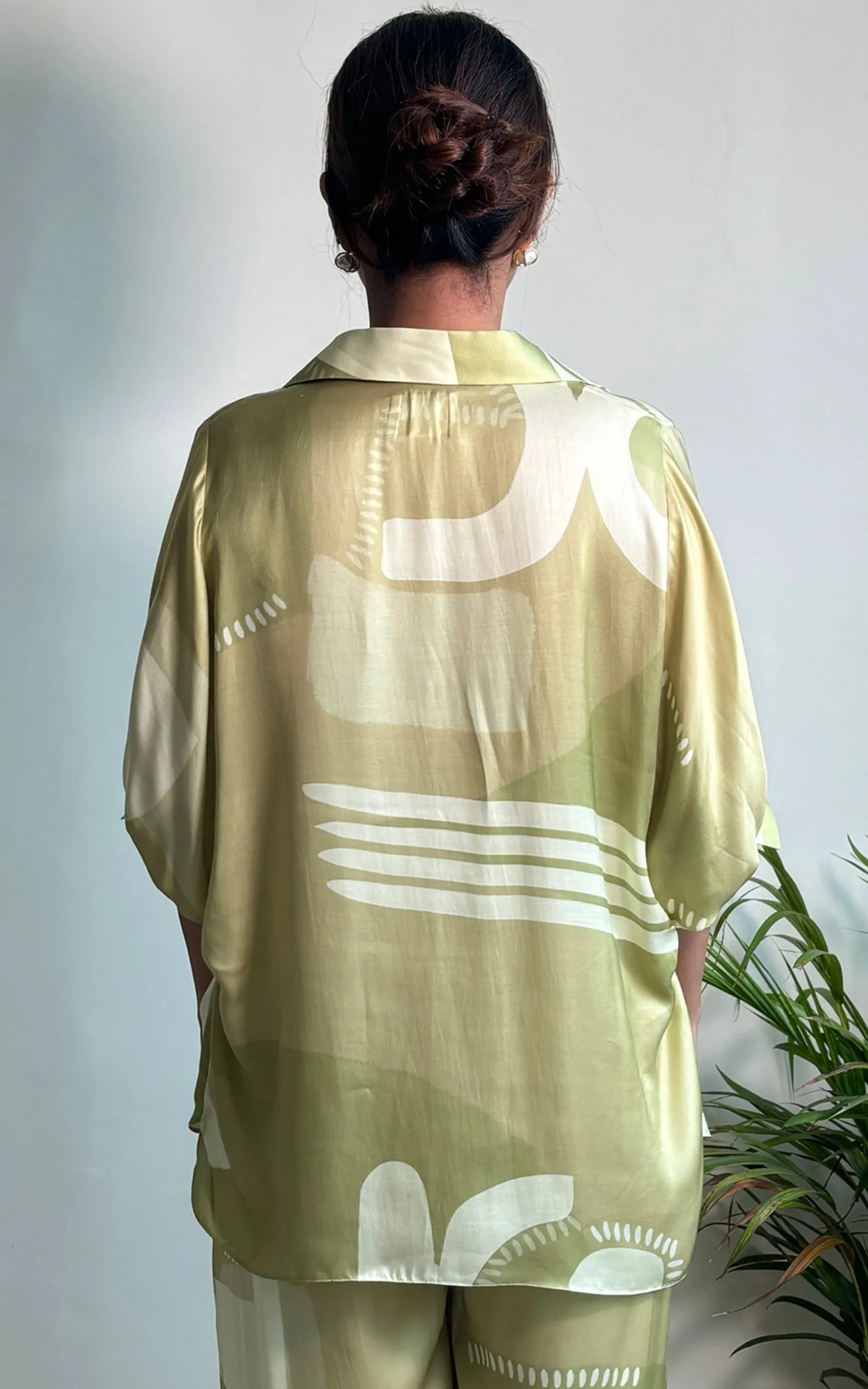 Green Abstracted Printed V neck Top.